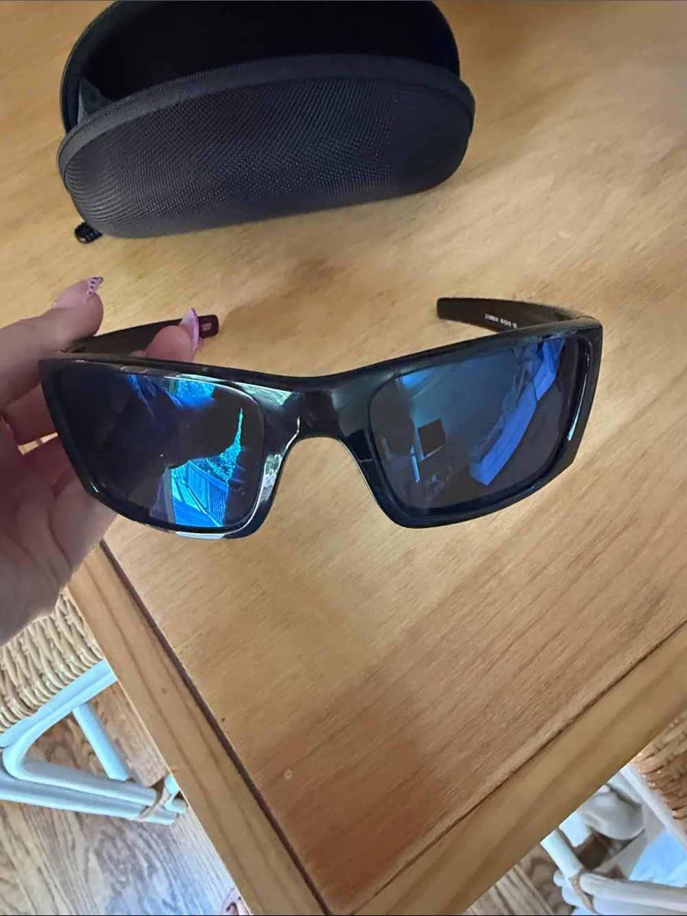 Oakley Black Frame Sunglasses with Blue Mirrored Lenses